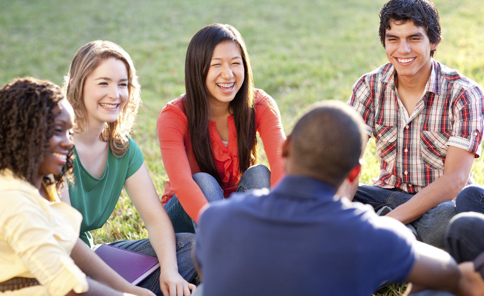 Image of students sitting in a circle.