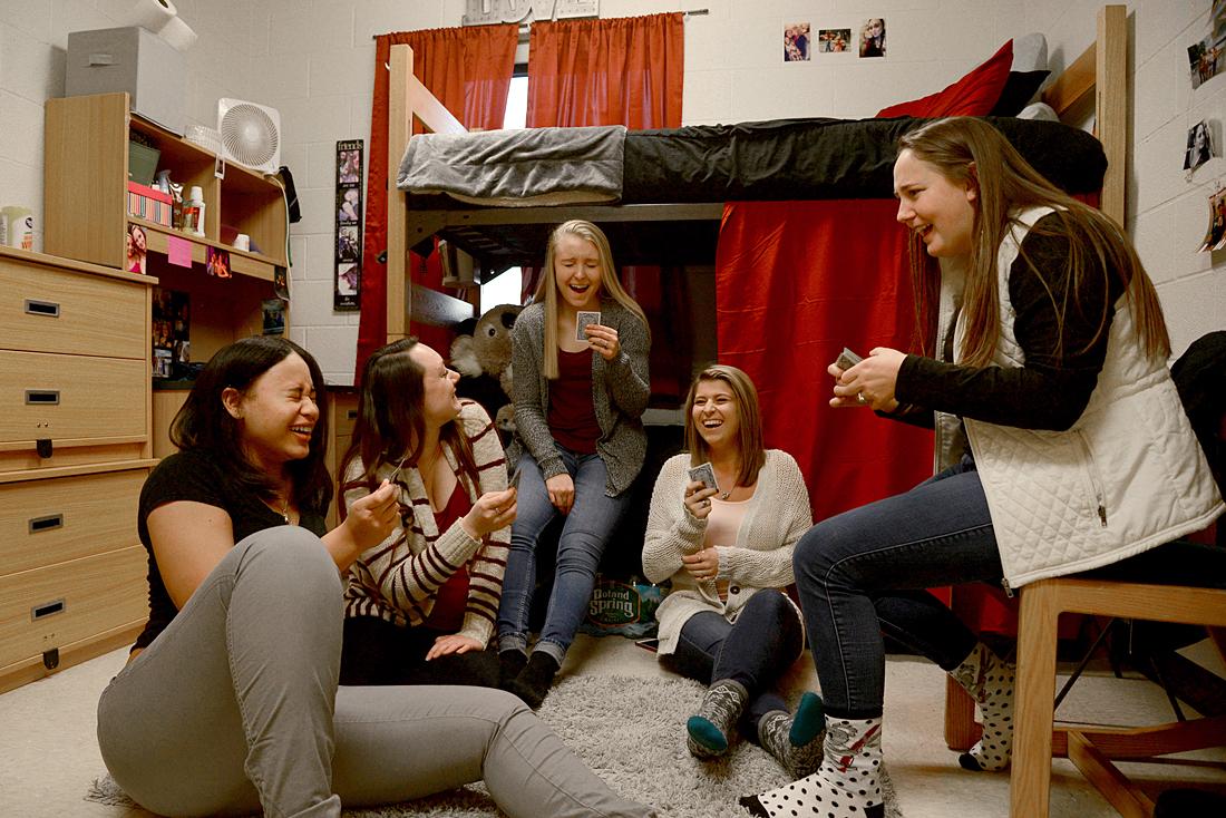 Group of students laughing in dorm room