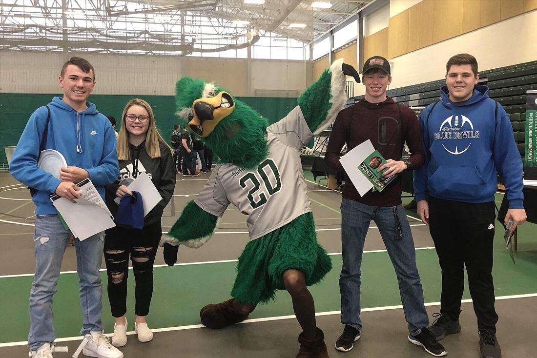 MVCC mascot Mo Hawk with students at Open House