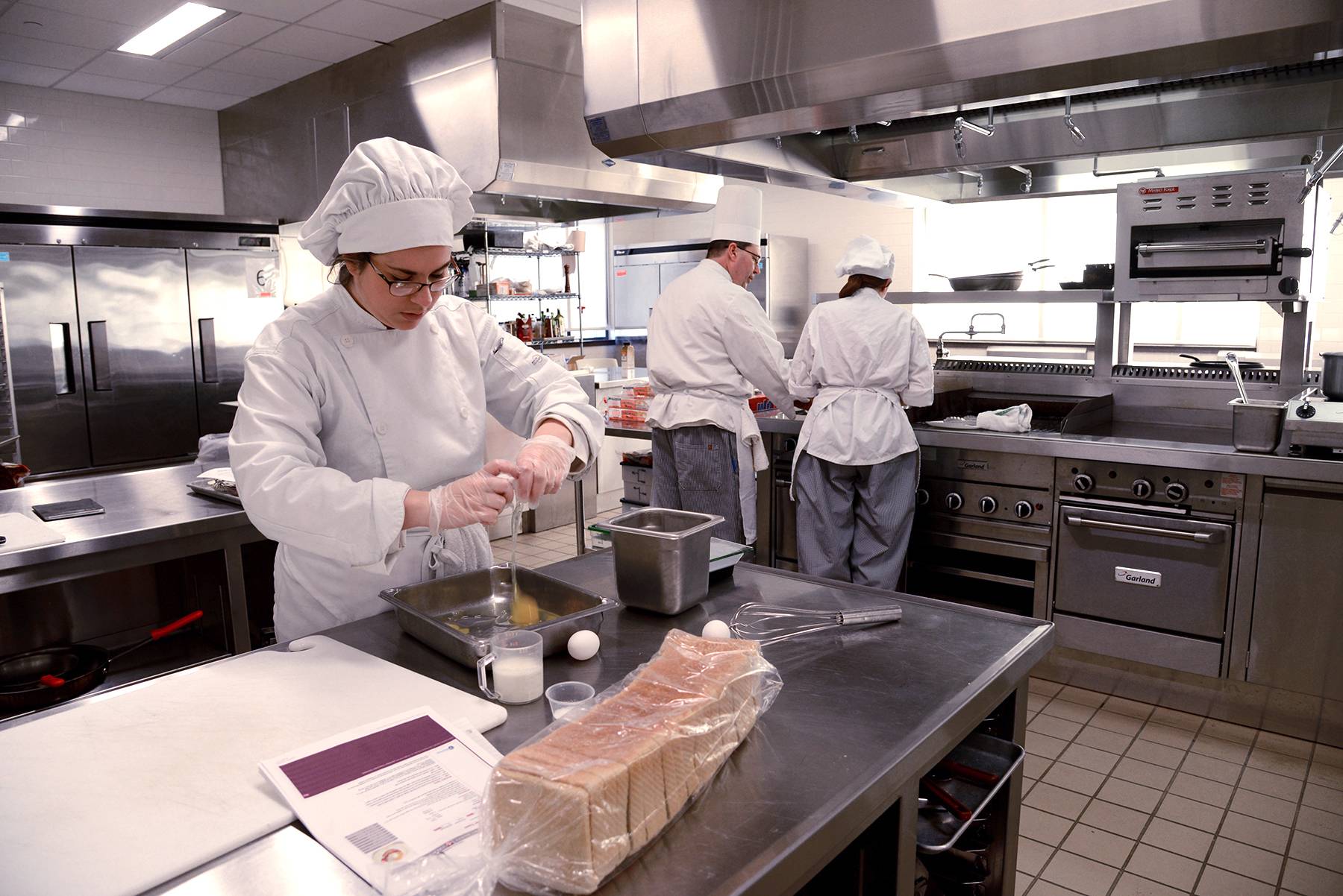 Culinary arts students working in kitchen