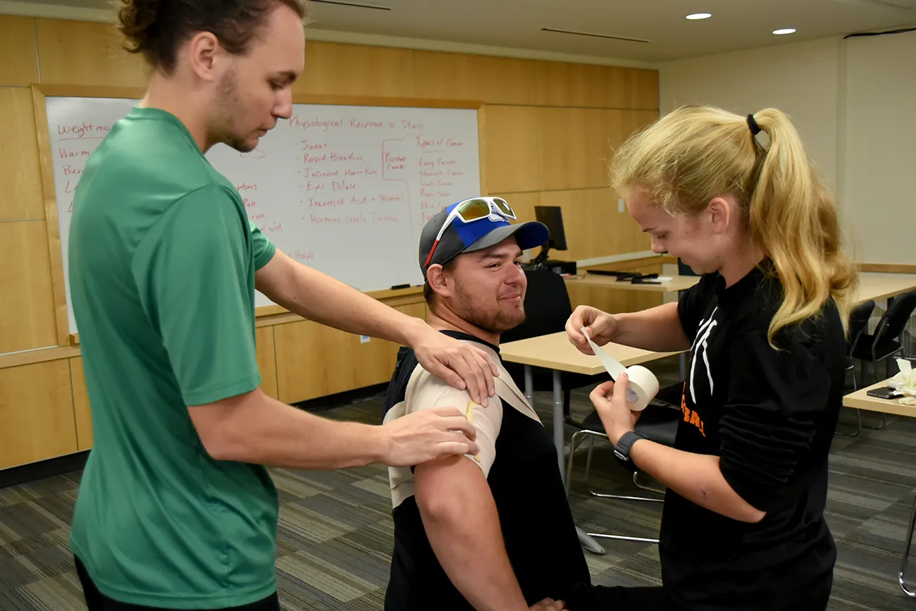 Sports Medicine students practice taping in class