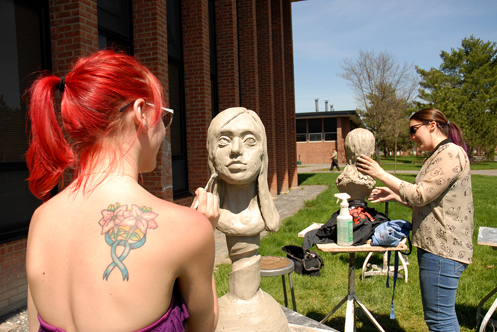 Sculpture students working outdoors