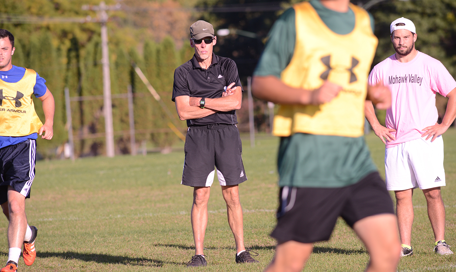 Coach and players on soccer field