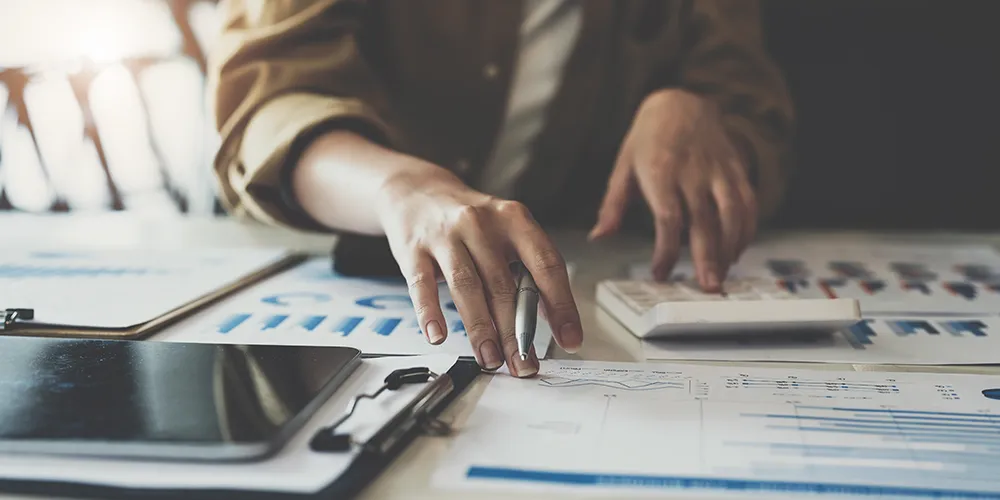 Bookkeeper looking at charts and data tables