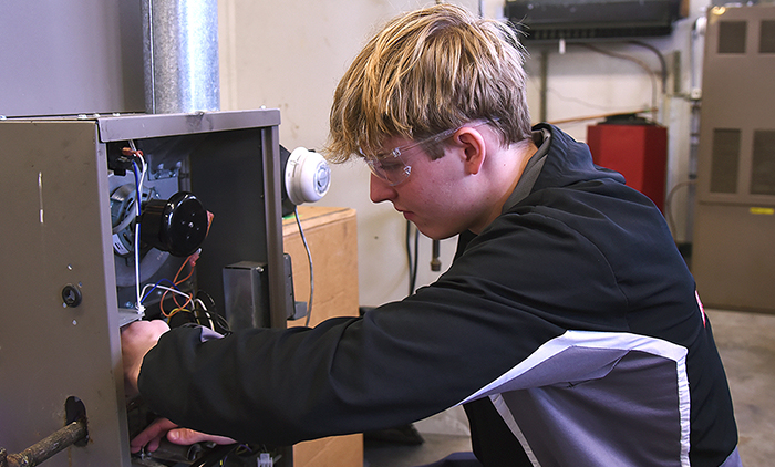 Student working on HVAC unit