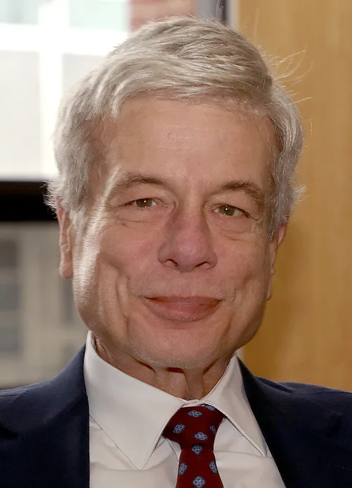 Image of person in suit, smiling