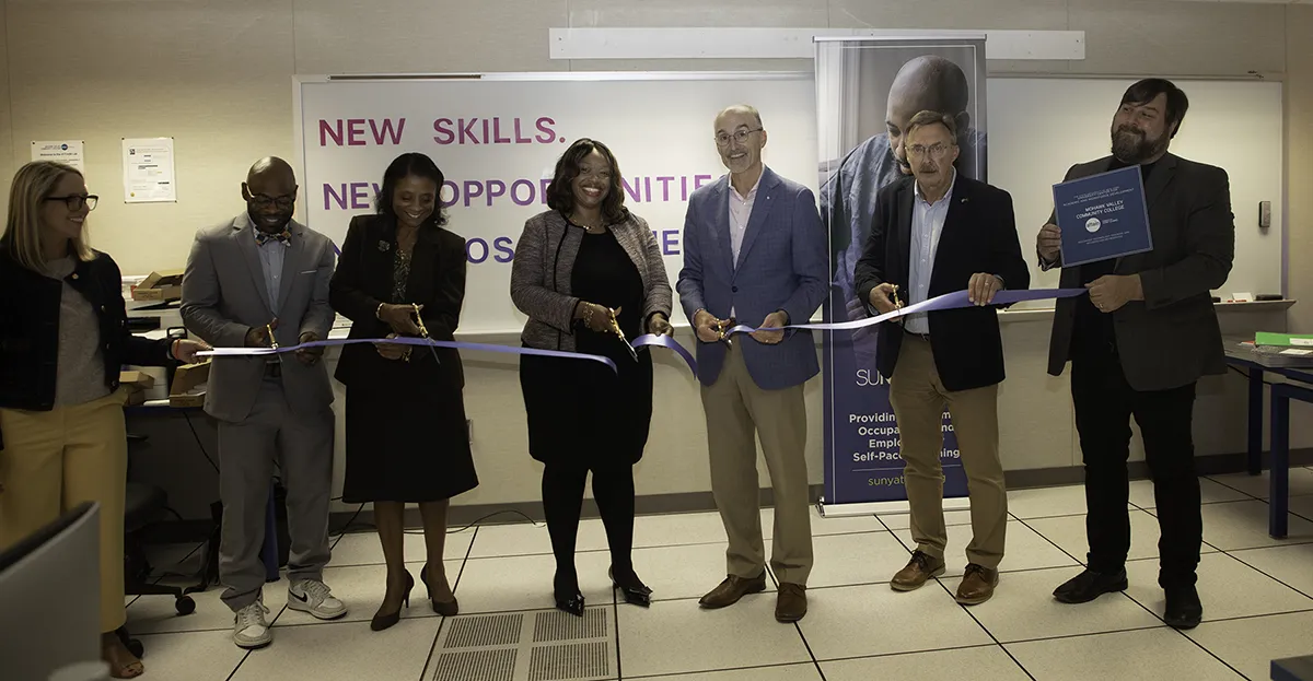 ATTAIN Lab Ribbon-Cutting Seven people standing together, cutting a blue ribbon