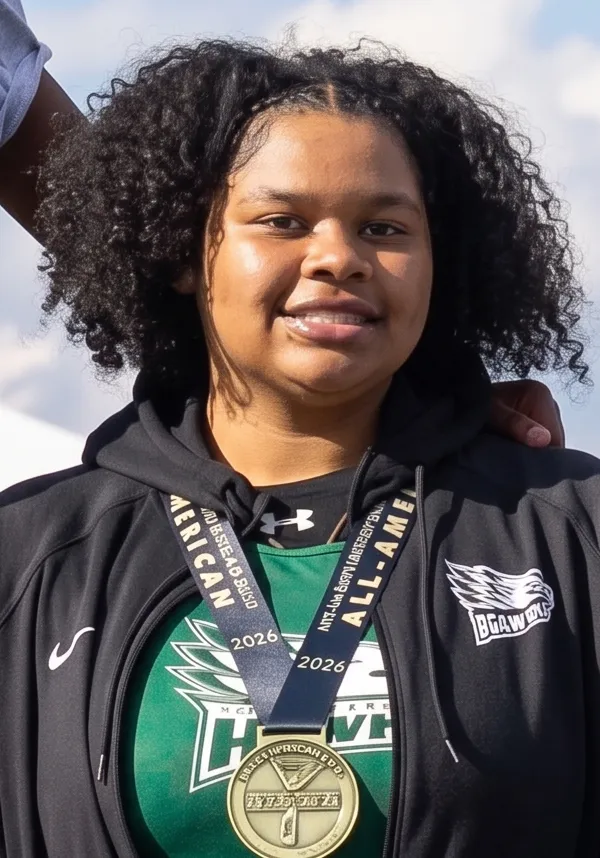 Person wearing sports medals, smiling