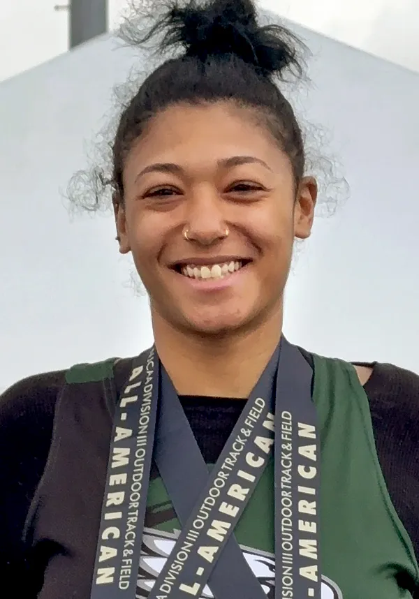 Person wearing sports medals, smiling