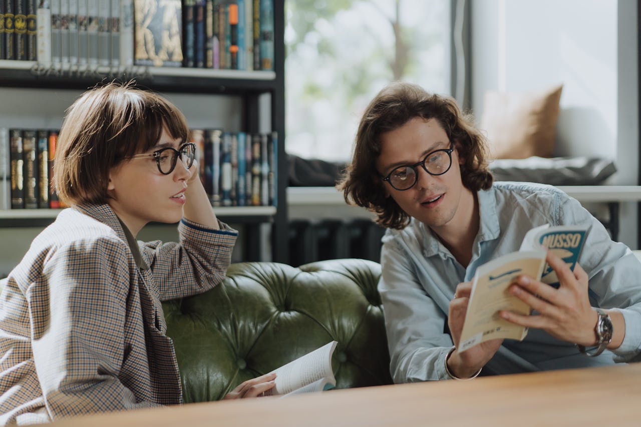 image of two people reading a book